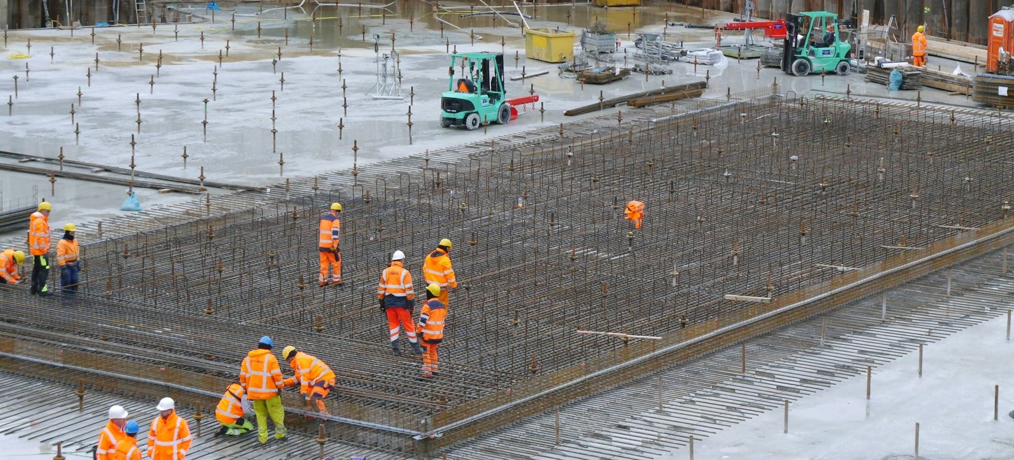 a group of construction workers standing around a construction site